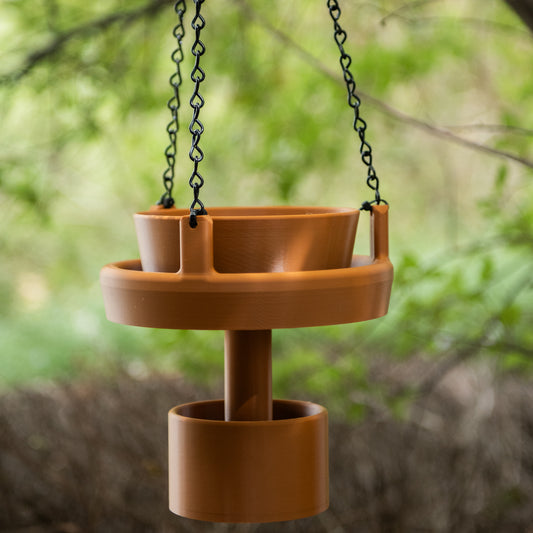 Terracotta Bird Feeder with base weight hanging from a tree branch