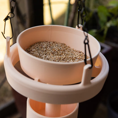 Cream Bird Feeder Original with removable bowl hanging outdoors